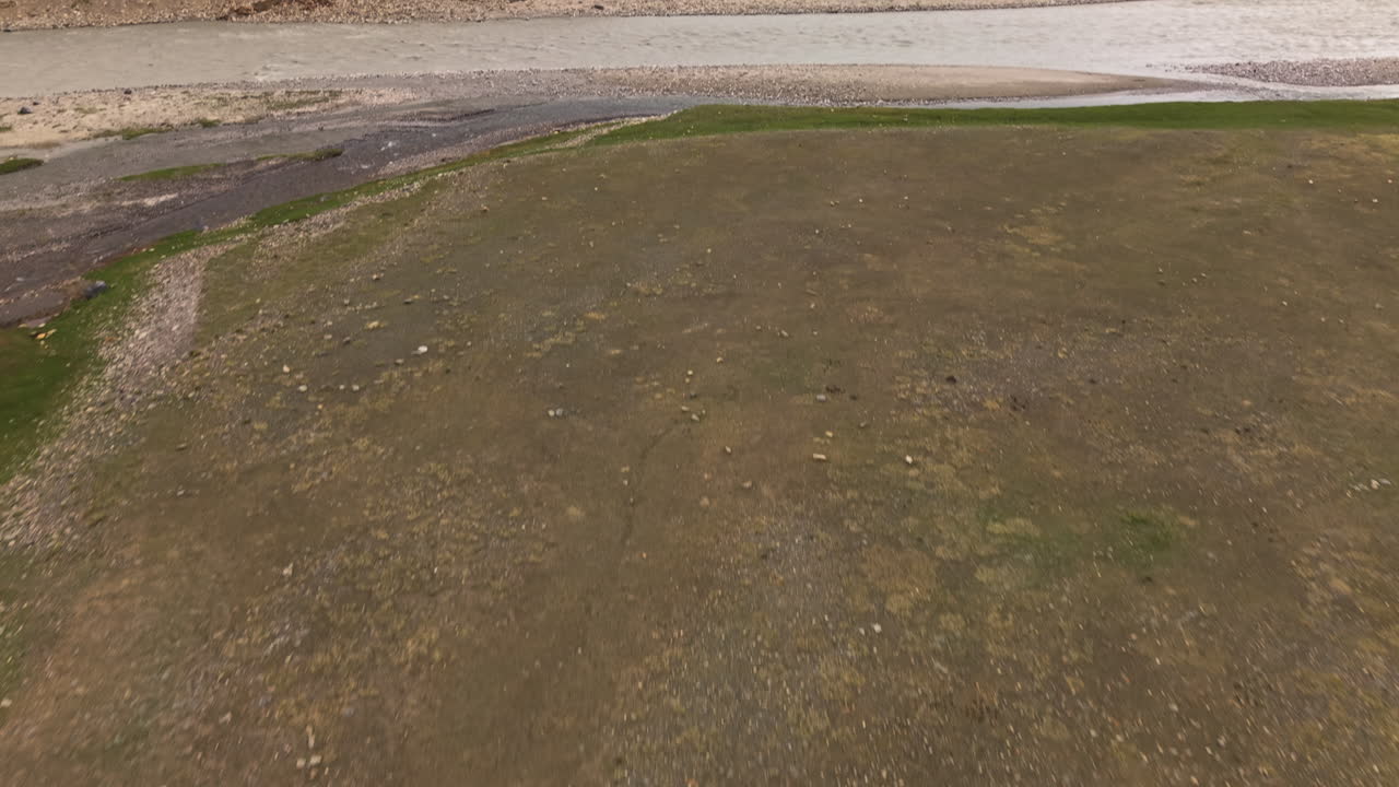 Tian Shan Mountains And Glacier River In The Kurumduk Valley Of Naryn Province In Kyrgyzstan. Aerial Tilt-up Shot