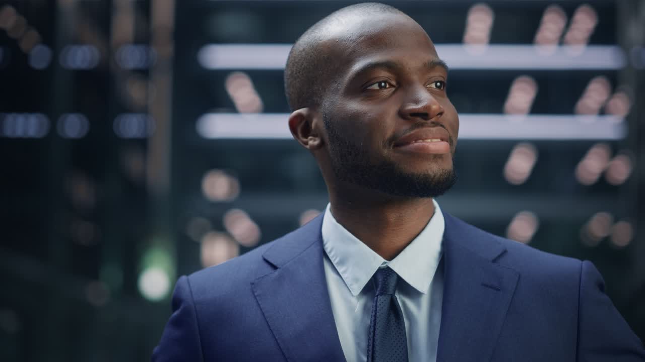 Portrait of Thoughtful Black Businessman wearing Suit, Standing in the Big City Business District Street, Looking Afar at the Opportunity and Future Success. African American Digital Entrepreneur