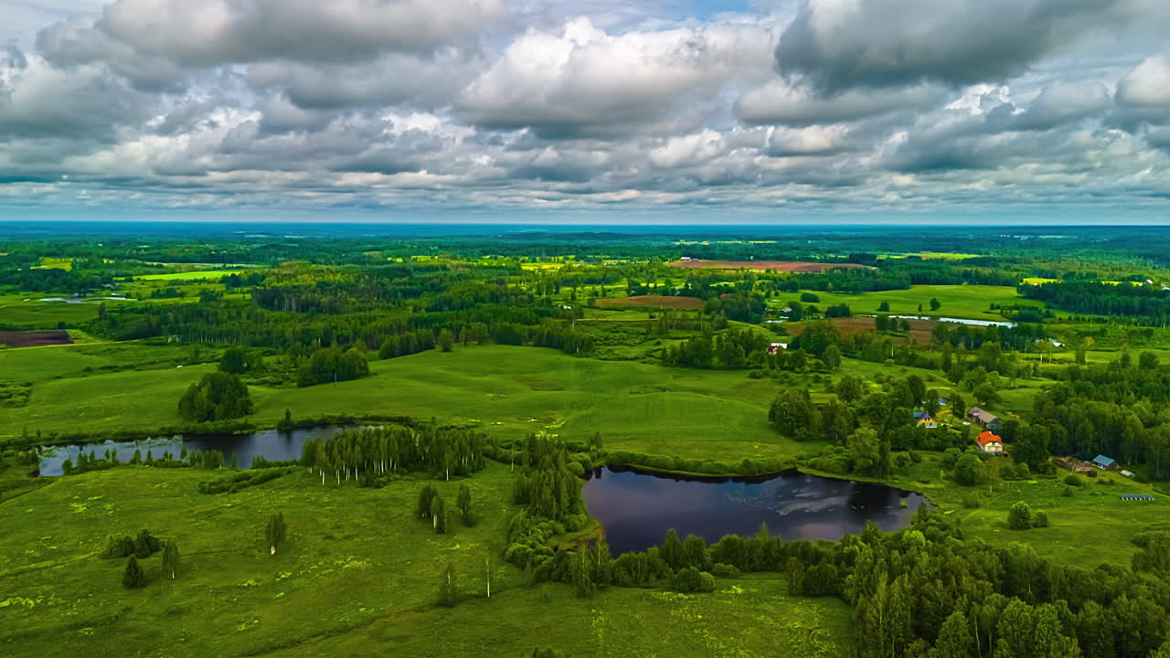 Thick Clouds Passing Over Evergreen Countryside Landscape. Timelapse