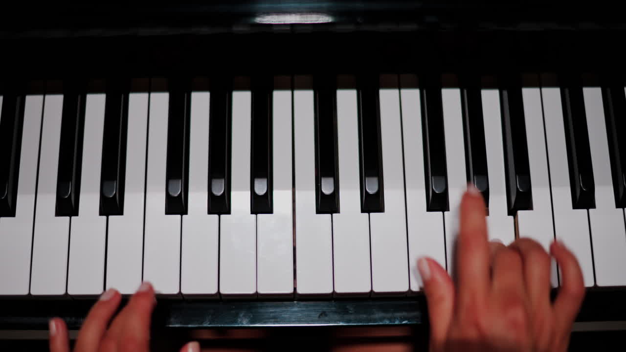 Close up of a woman's hands playing the piano