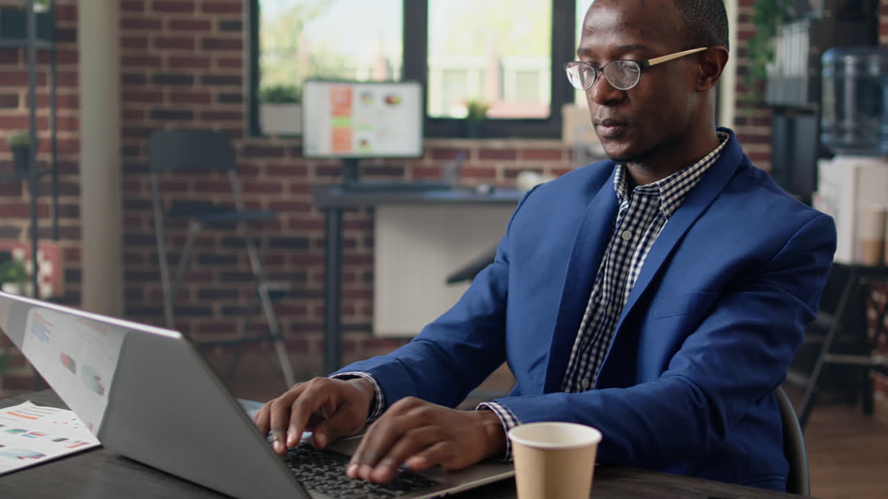 Businessman planning financial strategy in brick wall office
