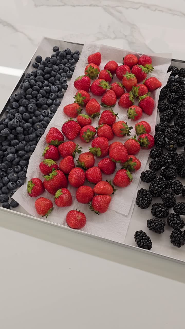 A vibrant collection of berries ready for cake and muffin toppings at a bakery shop.
