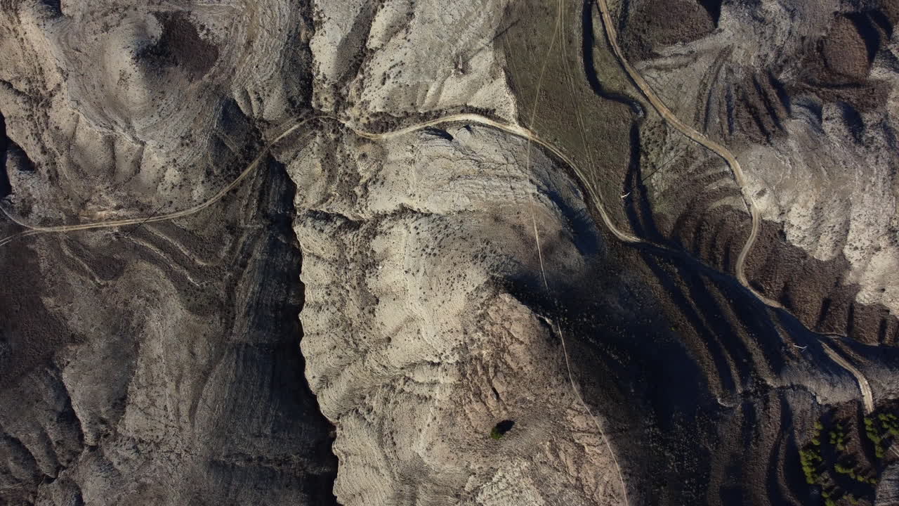 Aerial View of a Rugged, Dry Landscape with Winding Paths