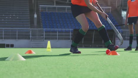 Female-hockey-players-training-on-a-field