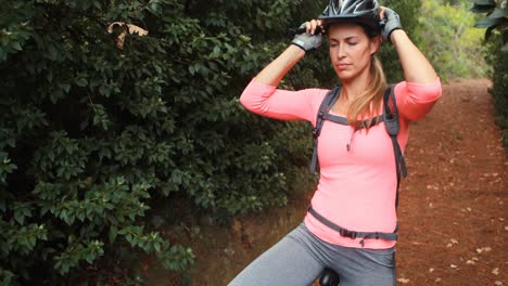 Female-cyclist-taking-a-break-while-cycling-in-forest