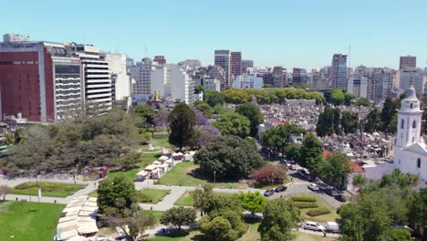 Aerial-view-establishing-the-northern-neighborhood-of-the-Ciudad-Autónoma-de-Buenos-Aires,-many-green-areas-to-walk-in-spring-on-a-sunny-day