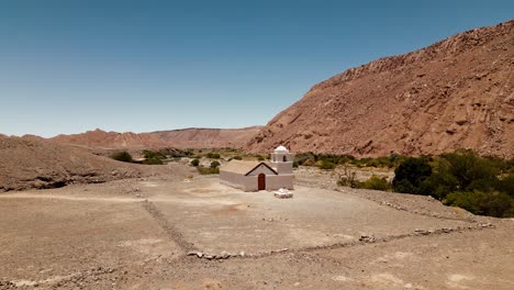 discover a hidden gem of the atacama desert with stunning drone footage showcasing a small church nestled in a verdant oasis valley, a sight to behold from above