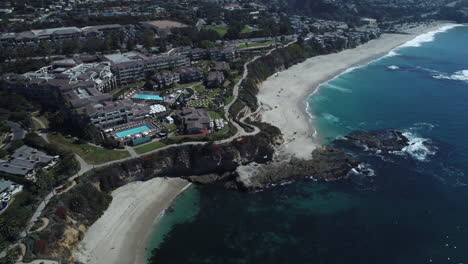 Cinematic-drone-shot-of-beautiful-Laguna-Beach,-California-in-midday-sunshine