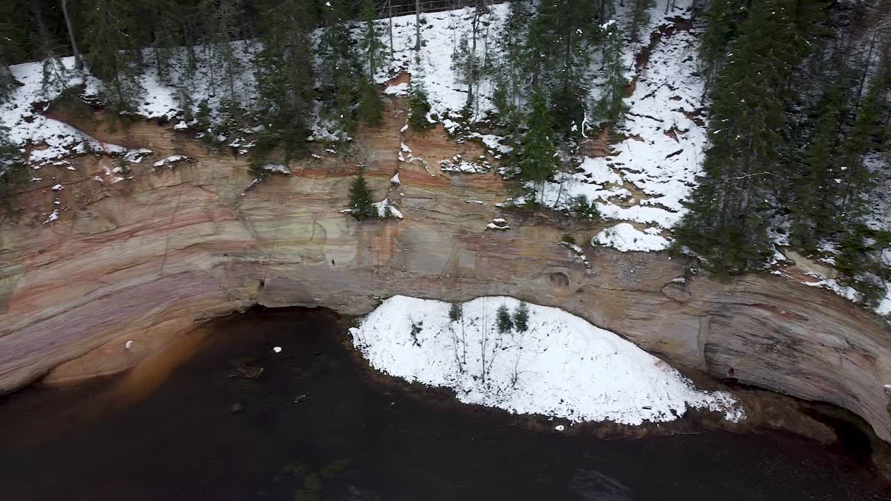 vista aérea del afloramiento del acantilado de arena junto a un río en invierno