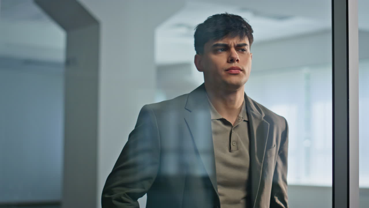 Frustrated businessman checking smartphone at office closeup. Man touching head