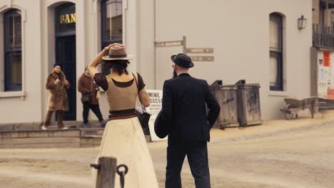 couple walking towards a bank in period attire