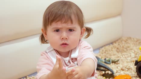 charming portrait of a toddler showing an upset facial expression