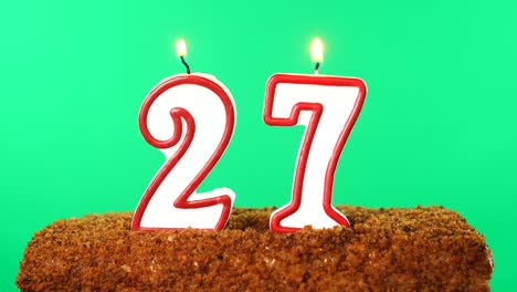 cake with the number 27 lighted candle. chroma key. green screen. isolated