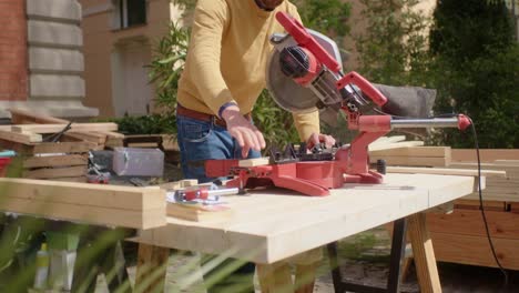 The-craftsman-saws-the-wood-to-size-at-the-workstation