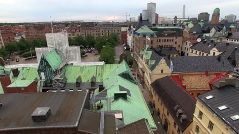 malmö aerial drone shot over city street and buildings and town square