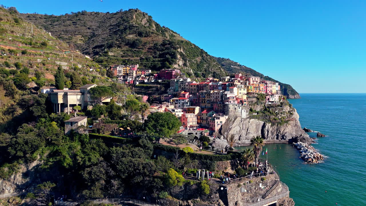 Colorful Manarola village perched on rocky cliffs, overlooking the Mediterranean Sea
