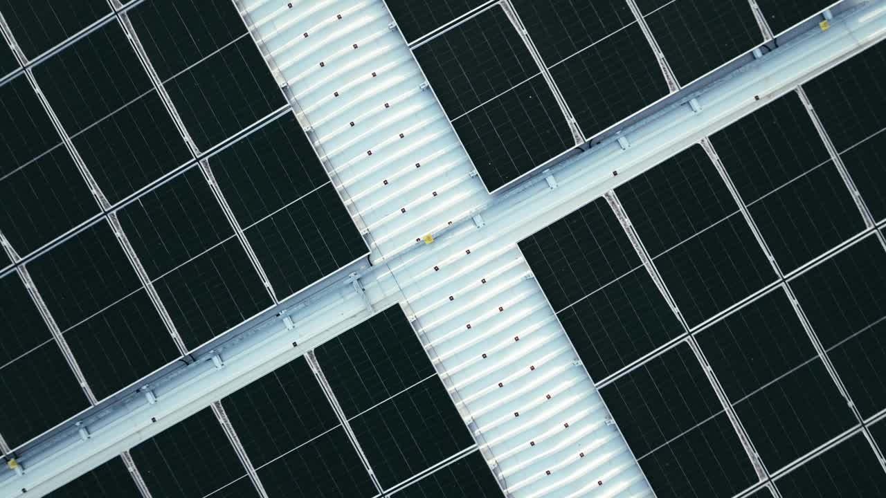 An aerial view capturing a solar panel installation on a rooftop.top-down perspective.