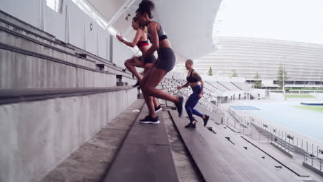 women running up stadium steps