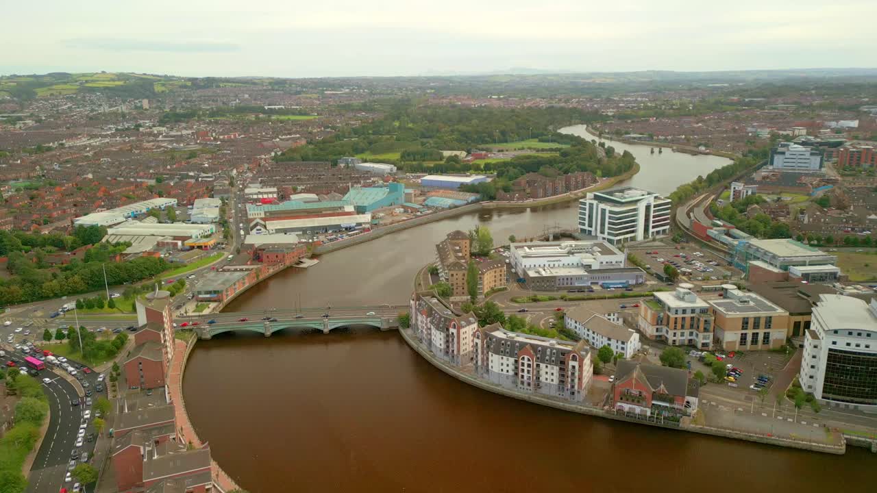 Push-in 4K aerial video of Queen's Bridge in Belfast City centre on a bright and sunny afternoon. Produced in 4K, 60FPS and with Rec709 color