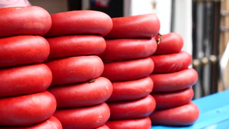 stacks of red turkish sucuk sausage at a market