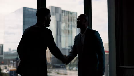 businessmen shaking hands in office