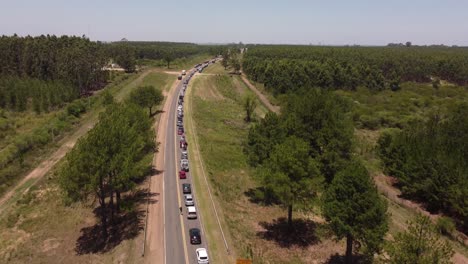 Traffic-Jam-Along-Distant-Rural-Landscape,-Gualeguachu-Fray-Bentos-Border,-Argentina