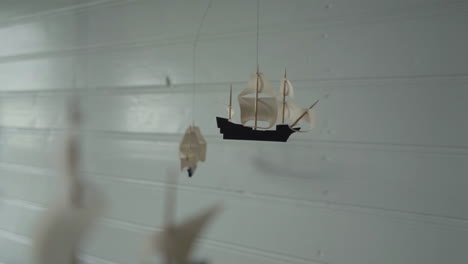 mobile of handmade ships hanging from ceiling