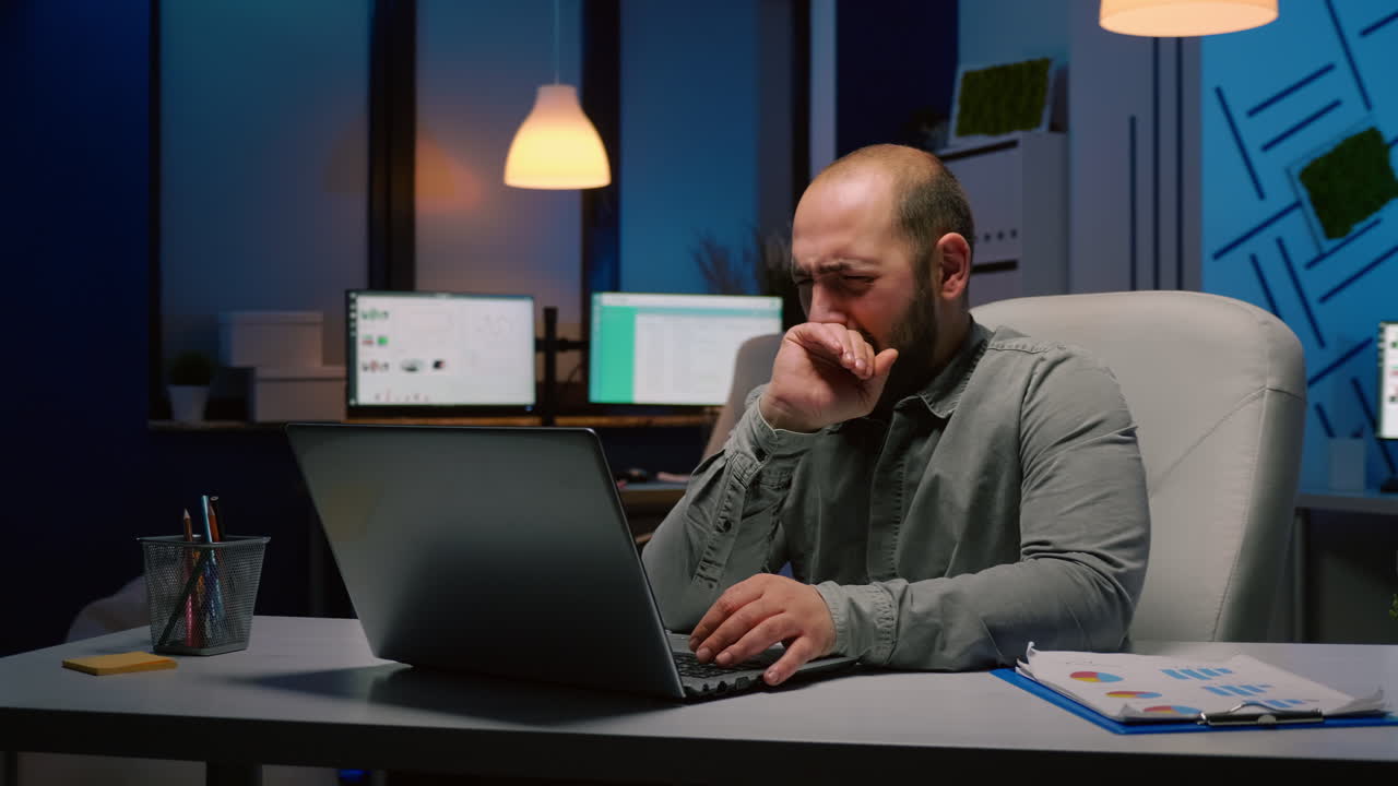 Exhausted businessman working overtime at financial company deadline