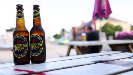 two beer bottles on an outdoor table