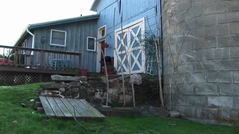 a sideview of modest home and barnlike door of the garage