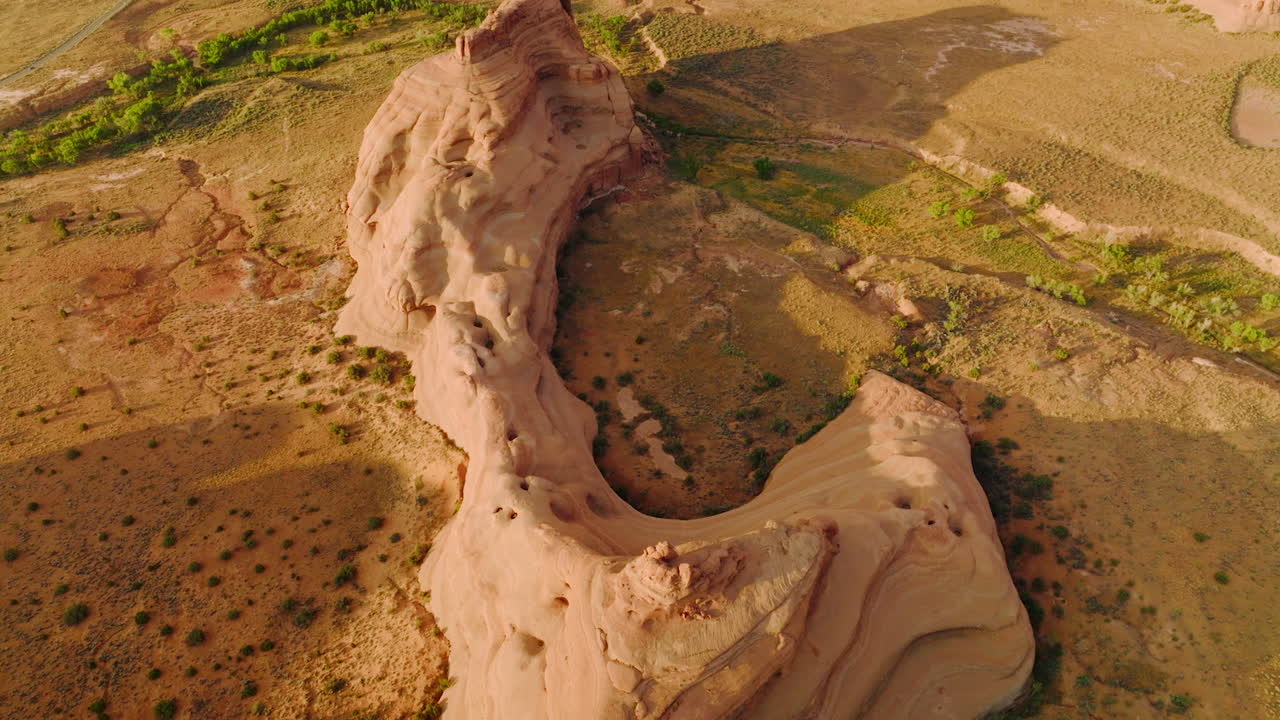 Unusual shape of rocks in the national park of Utah, USA. Drone flying over dry desert land with little greenery.