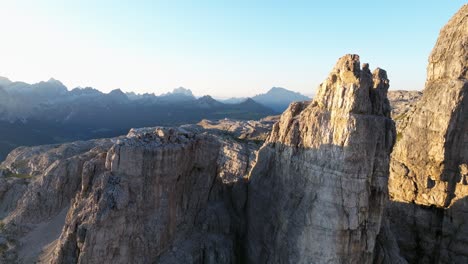 breathtaking drone perspective of the dolomites, capturing the interplay of light and shadow as clouds roll over its majestic peaks, revealing nature's drama and splendor