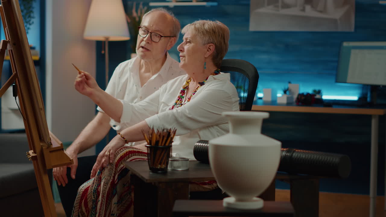 Senior man and woman looking at vase design to draw masterpiece