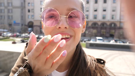 woman blowing a kiss in the city