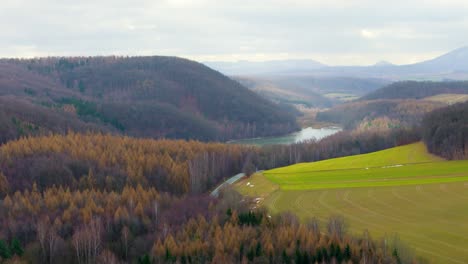 A-Small-Lake-Among-A-Dense-Autumn-Forest-In-The-Mountains