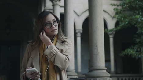 woman putting on earphones