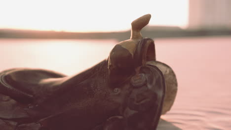 old horse saddle on the beach