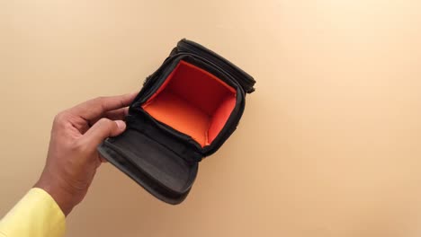 person opening camera bag