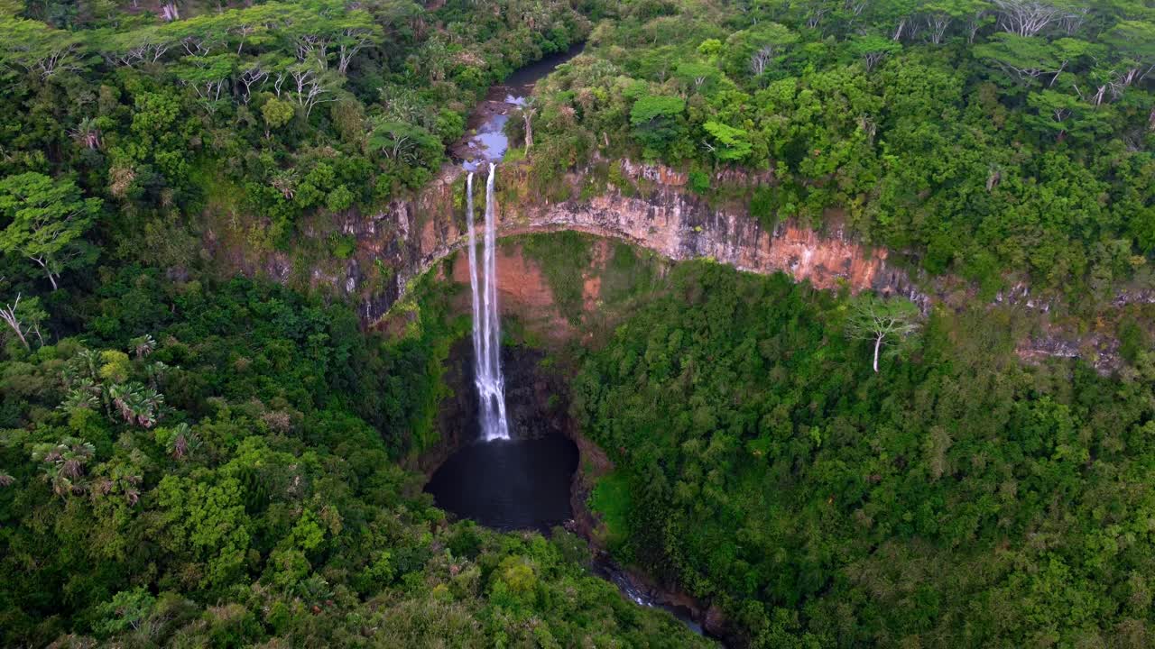 Aerial View of a Stunning Waterfall in a Lush Tropical Forest