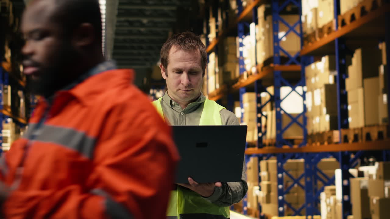 Portrait of worker checking shipment labels in modern warehouse facility