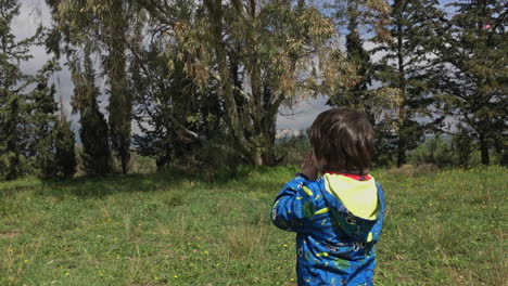 a little boy yelling at woods, located at kifissia, greece