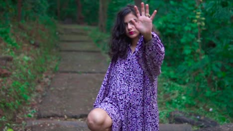 Portrait-of-a-friendly-woman-waving-her-hand-and-looking-at-the-camera-with-a-serious-face