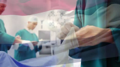 Animation-of-flag-of-netherlands-waving-over-surgeons-in-operating-theatre