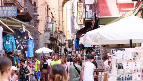 crowded street with tourists and market stalls