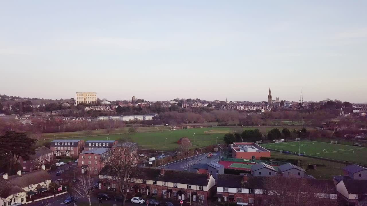 An aerial pan of the Exeter horizon at sunset