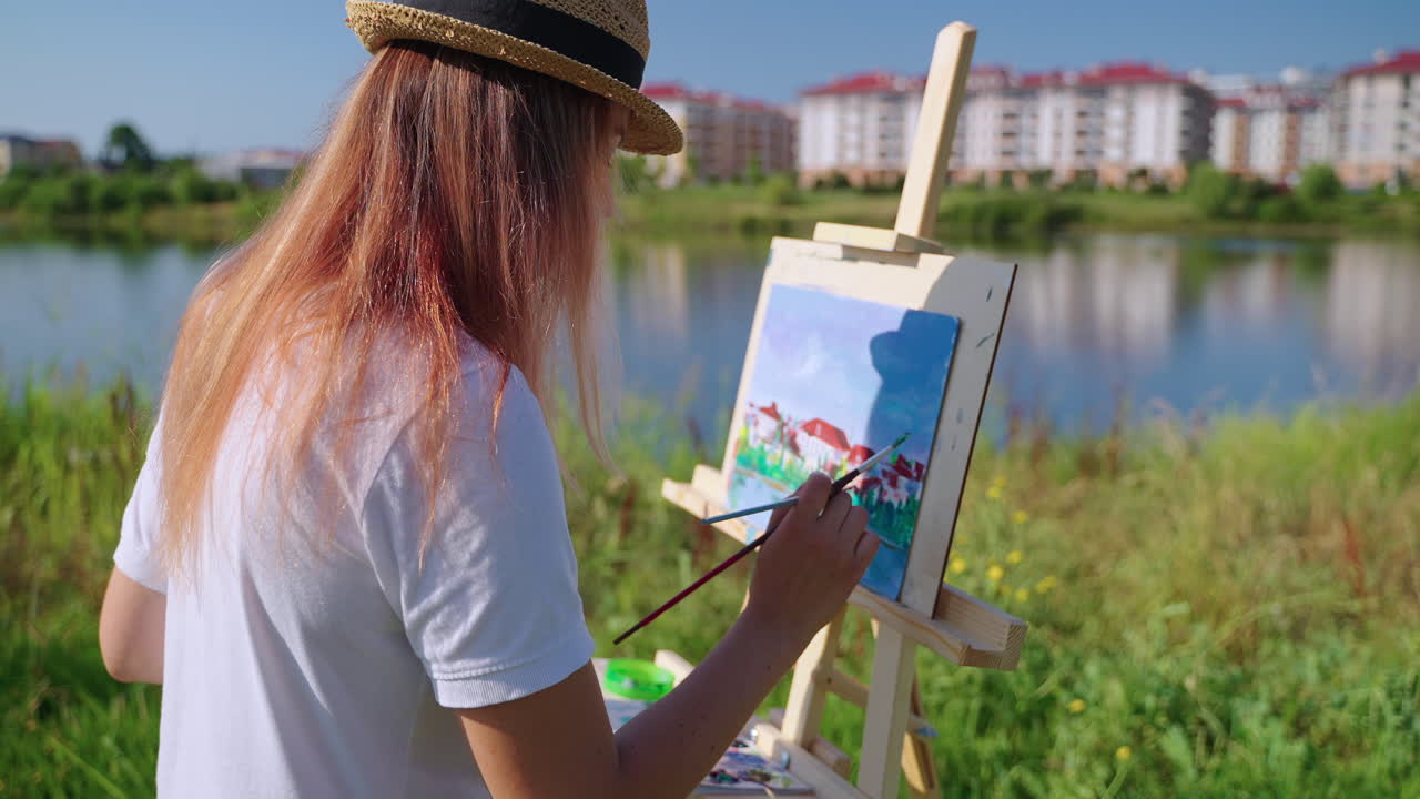 Woman painting a landscape outdoors