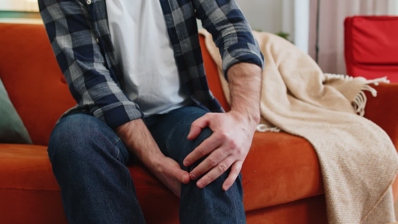 Unrecognizable man suffer from painful severe knee joint ache leg muscles illness cramps rheumatism
