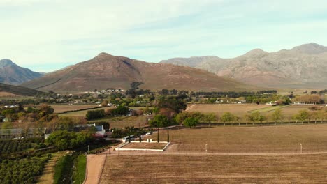 drone shot orbits around the small village town, whilst it reveals the whole town.