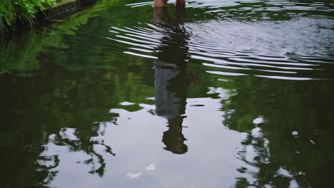 person walking through a puddle