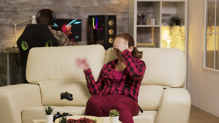 Woman playing video games on console in living room